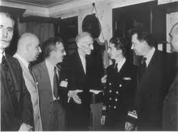Nikola Tesla in a meeting with several notable individuals